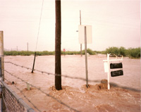 Photo showing Camino Verde Road and Bilby Road intersection during a July 1990 flood.