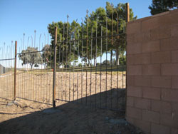 Wrought iron fence along multi-use path.